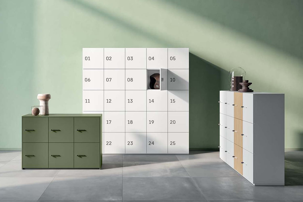 Sfeerbeeld van lockerkasten met genummerde deurtjes in groen en wit naast een lage ladekast