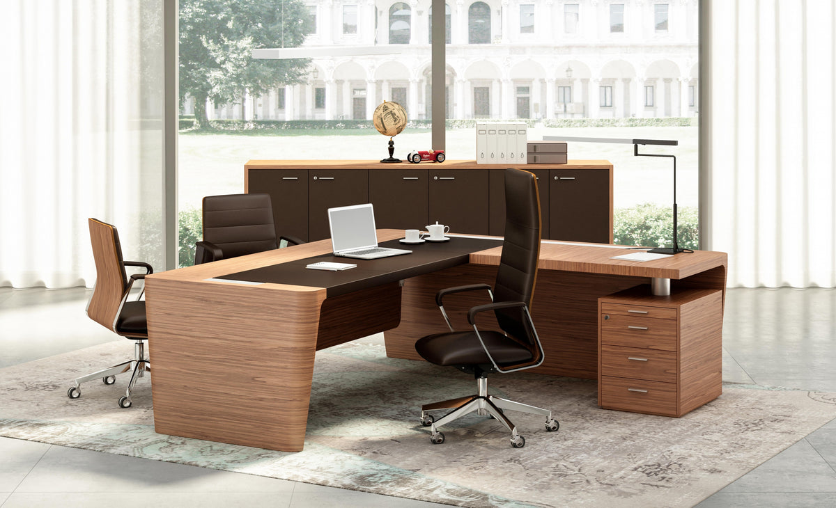 Directiekantoor met het notenhouten hoekbureau, twee bezoekersstoelen en een dressoir bij het raam